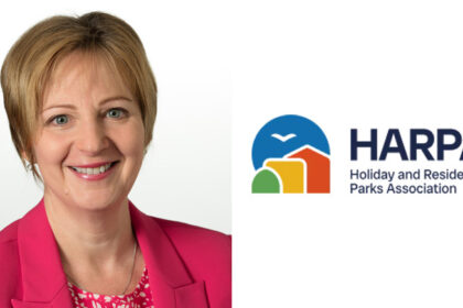 Harpa Director General Debbie Walker next to the harpa logo